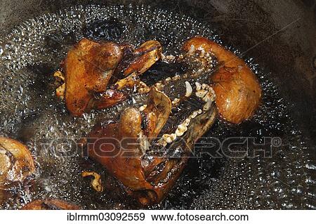 Stock Photo - "Slaughtered and dissected dogs being fried in hot oil, Siem Reap, Siem Reap, Siem Reap Province, Cambodia, Asia". Fotosearch