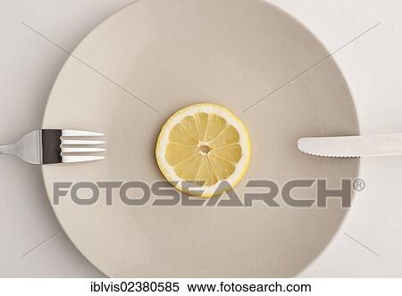 Slice of lemon on a plate View Large Photo Image Stock Photography - Slice of lemon on a plate. Fotosearch