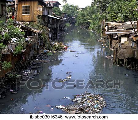 Stock Photograph - "Slum, filthy canal, huts, poverty, waste, Manila, Luzon, Philippines, Asia". Fotosearch