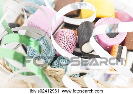 Small basket filled with liquorice candy and decorated with silver streamer View Large Photo Image Stock Image - Small basket filled with liquorice candy and decorated with silver streamer. Fotosearch