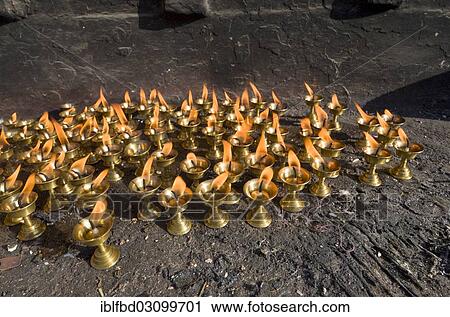 "Small butterlamps, lighted, for sale as offerings, Kathmandu, Kathmandu District, Bagmati Zone, Nepal, Asia" View Large Photo Image Stock Image - "Small butterlamps, lighted, for sale as offerings, Kathmandu, Kathmandu District, Bagmati Zone, Nepal, Asia". Fotosearch