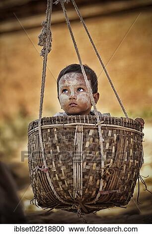"Small child being carried in a basket, Bagan, Burma also known as Myanmar, Southeast Asia, Asia" View Large Photo Image Stock Image - "Small child being carried in a basket, Bagan, Burma also known as Myanmar, Southeast Asia, Asia". Fotosearch