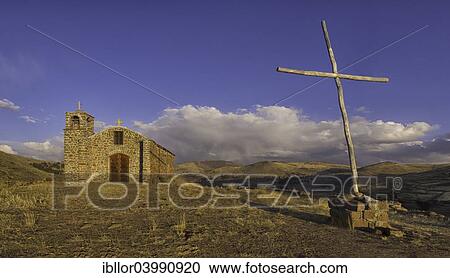 Stock Image - "Small church and cross in the backcountry, Bolivian plateau Altiplano, Santiago De Huata, La Paz, Bolivia, South America". Fotosearch