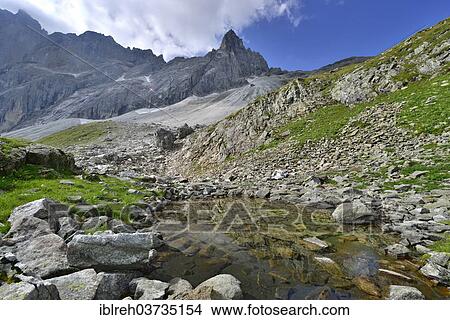 "Small mountain lake in front of Pflerscher Tribulaun, Goldkappl and Pflerscher Scharte mountains, Gschnitztal valley, Tyrol, Austria, Europe" View Large Photo Image Picture - "Small mountain lake in front of Pflerscher Tribulaun, Goldkappl and Pflerscher Scharte mountains, Gschnitztal valley, Tyrol, Austria, Europe". Fotosearch