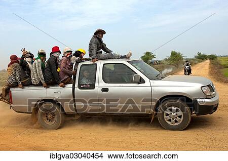"Small pickup truck carrying farm workers in the crowded cargo bay on a country road, Cambodia, Asia" View Large Photo Image Picture - "Small pickup truck carrying farm workers in the crowded cargo bay on a country road, Cambodia, Asia". Fotosearch