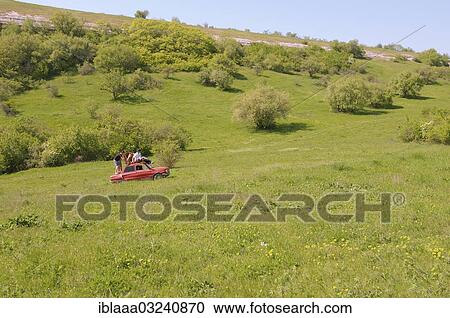 "Small red car, Zaporozhets, driving across a meadow, Crimean Mountains, Crimea, Ukraine, Europe" View Large Photo Image Stock Image - "Small red car, Zaporozhets, driving across a meadow, Crimean Mountains, Crimea, Ukraine, Europe". Fotosearch