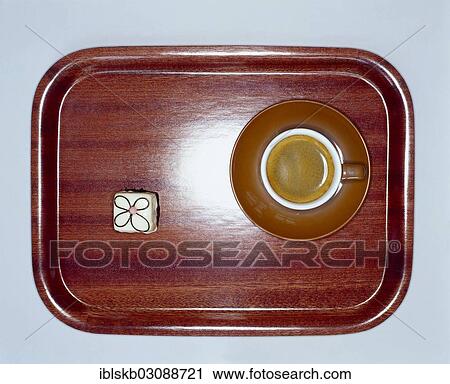 Small wooden tray with coffee and a petit four from above View Large Photo Image Stock Image - Small wooden tray with coffee and a petit four from above. Fotosearch