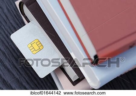 "Smart card in a stack of books, symbolic image for an educational smart card" View Large Photo Image Stock Image - "Smart card in a stack of books, symbolic image for an educational smart card". Fotosearch