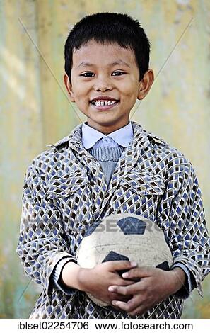 "Smiling Asian boy with a football in his hands, portrait, Burma, Myanmar, Southeast Asia, Asia" View Large Photo Image Stock Photograph - "Smiling Asian boy with a football in his hands, portrait, Burma, Myanmar, Southeast Asia, Asia". Fotosearch