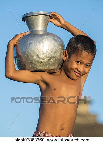 "Smiling boy carrying water in a water container made of aluminium, Mrauk U, Sittwe District, Rakhine State, Myanmar, Asia" View Large Photo Image Stock Image - "Smiling boy carrying water in a water container made of aluminium, Mrauk U, Sittwe District, Rakhine State, Myanmar, Asia". Fotosearch