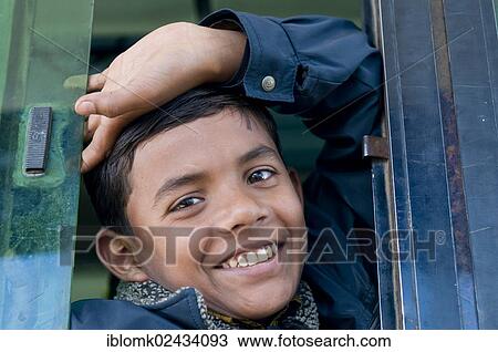 "Smiling boy looking out of an open bus windows, Bhandavgarh, Madhya Pradesh, India, Asia" View Large Photo Image Stock Image - "Smiling boy looking out of an open bus windows, Bhandavgarh, Madhya Pradesh, India, Asia". Fotosearch