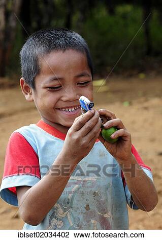 "Smiling boy with a toy car in Laos, Southeast Asia, Asia" View Large Photo Image Stock Image - "Smiling boy with a toy car in Laos, Southeast Asia, Asia". Fotosearch