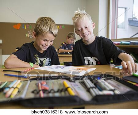 "Smiling children sitting in a primary school class during a drawing lesson, Reith im Alpbachtal, Kufstein district, Tyrol, Austria, Europe" View Large Photo Image Stock Photo - "Smiling children sitting in a primary school class during a drawing lesson, Reith im Alpbachtal, Kufstein district, Tyrol, Austria, Europe". Fotosearch