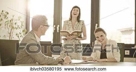 "Smiling colleagues in a conference room, Innsbruck, Tyrol, Austria, Europe" View Large Photo Image Stock Photography - "Smiling colleagues in a conference room, Innsbruck, Tyrol, Austria, Europe". Fotosearch