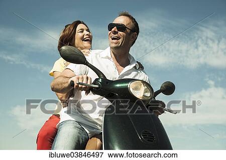 "Smiling couple driving with the scooter, Mannheim, Baden-Wurttemberg, Germany, Europe" View Large Photo Image Stock Photo - "Smiling couple driving with the scooter, Mannheim, Baden-Wurttemberg, Germany, Europe". Fotosearch