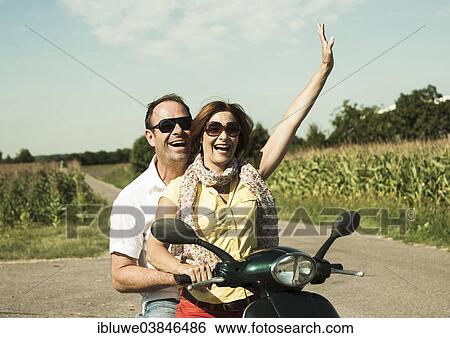 "Smiling couple driving with the scooter, Mannheim, Baden-Wurttemberg, Germany, Europe" View Large Photo Image Stock Photograph - "Smiling couple driving with the scooter, Mannheim, Baden-Wurttemberg, Germany, Europe". Fotosearch