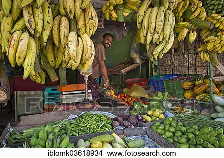 Picture - "Smiling fruit and vegetable seller, Vembanad lake, Kerala, India, Asia". Fotosearch