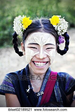 "Smiling girl wearing thanaka paste on her face and flowers in her hair, Bagan, Myanmar, Burma, Southeast Asia, Asia" View Large Photo Image Stock Image - "Smiling girl wearing thanaka paste on her face and flowers in her hair, Bagan, Myanmar, Burma, Southeast Asia, Asia". Fotosearch
