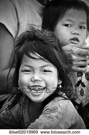 Stock Photo - "Smiling girl with bad teeth, another child at the back, Laos, Southeast Asia, Asia". Fotosearch