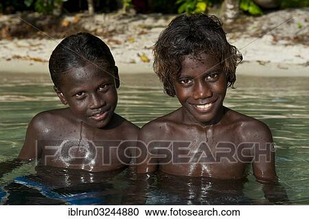 "Smiling local boys in the water of the Marovo Lagoon, Marovo Lagoon, Western Province, Solomon Islands, Oceania" View Large Photo Image Stock Image - "Smiling local boys in the water of the Marovo Lagoon, Marovo Lagoon, Western Province, Solomon Islands, Oceania". Fotosearch