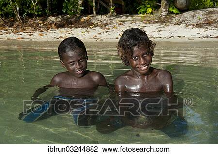 "Smiling local boys in the water of the Marovo Lagoon, Marovo Lagoon, Western Province, Solomon Islands, Oceania" View Large Photo Image Stock Image - "Smiling local boys in the water of the Marovo Lagoon, Marovo Lagoon, Western Province, Solomon Islands, Oceania". Fotosearch