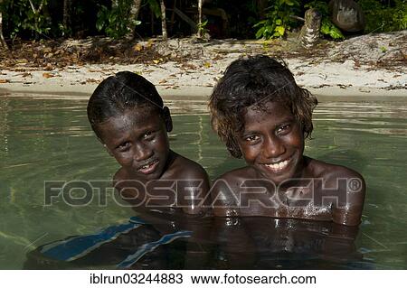 "Smiling local boys in the water of the Marovo Lagoon, Marovo Lagoon, Western Province, Solomon Islands, Oceania" View Large Photo Image Stock Image - "Smiling local boys in the water of the Marovo Lagoon, Marovo Lagoon, Western Province, Solomon Islands, Oceania". Fotosearch