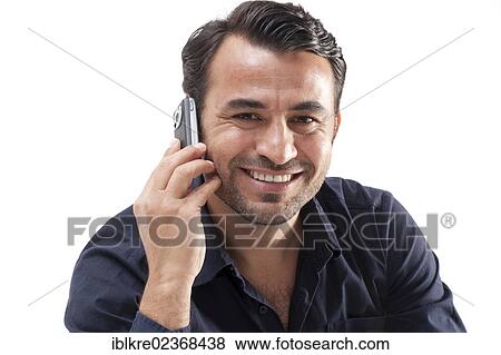 Smiling man talking on a mobile phone View Large Photo Image Stock Photo - Smiling man talking on a mobile phone. Fotosearch