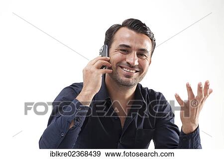 Smiling man talking on a mobile phone View Large Photo Image Stock Photo - Smiling man talking on a mobile phone. Fotosearch