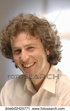 "Smiling man with curly hair, 30-40, portrait" View Large Photo Image Stock Image - "Smiling man with curly hair, 30-40, portrait". Fotosearch