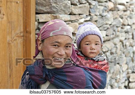 "Smiling woman carrying a child on her back, ethnic group of Lopa, Lo or Mustang, Nepal, Asia" View Large Photo Image Stock Photography - "Smiling woman carrying a child on her back, ethnic group of Lopa, Lo or Mustang, Nepal, Asia". Fotosearch