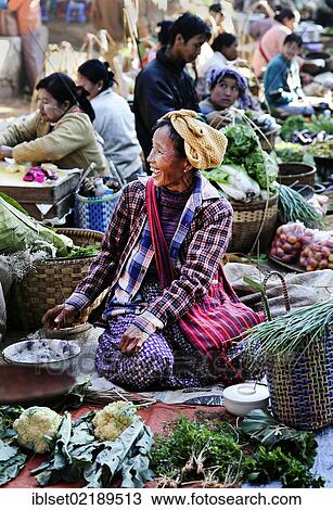 "Smiling woman selling vegetables at a market in Myanmar, Burma, Southeast Asia, Asia" View Large Photo Image Stock Image - "Smiling woman selling vegetables at a market in Myanmar, Burma, Southeast Asia, Asia". Fotosearch