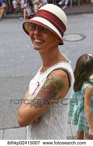 Smiling woman wearing a Panama hat and a summer dress, tattoo, retro look View Large Photo Image Stock Photo - Smiling woman wearing a Panama hat and a summer dress, tattoo, retro look. Fotosearch