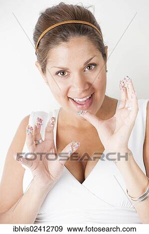 Stock Photo - Smiling woman with colorful sprinkles on her hands. Fotosearch