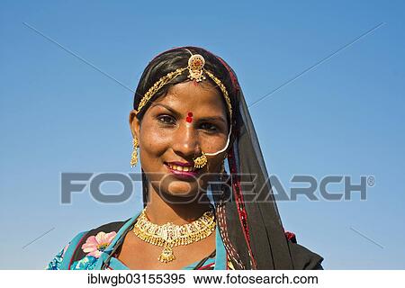 "Smiling young Indian woman with a headscarf and jewellery, portrait, Pushkar, Rajasthan, India, Asia" View Large Photo Image Stock Photography - "Smiling young Indian woman with a headscarf and jewellery, portrait, Pushkar, Rajasthan, India, Asia". Fotosearch