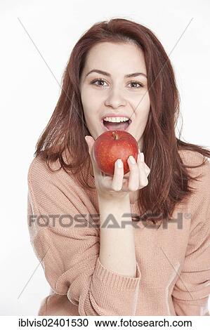 Smiling young woman holding apple View Large Photo Image Stock Image - Smiling young woman holding apple. Fotosearch