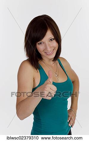 Smiling young woman making thumbs up gesture View Large Photo Image Stock Image - Smiling young woman making thumbs up gesture. Fotosearch
