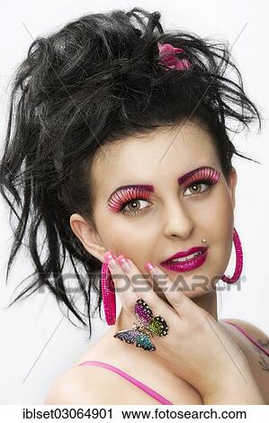 Stock Image - "Smiling young woman wearing pink makeup, Austria, Europe". Fotosearch
