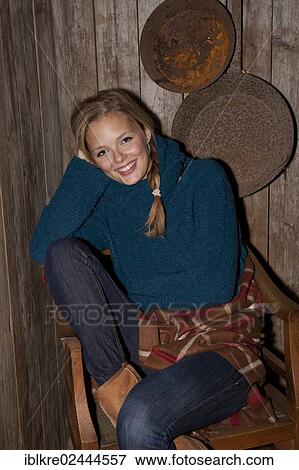 Smiling young woman with a blanket in a hiking hut View Large Photo Image Stock Photo - Smiling young woman with a blanket in a hiking hut. Fotosearch