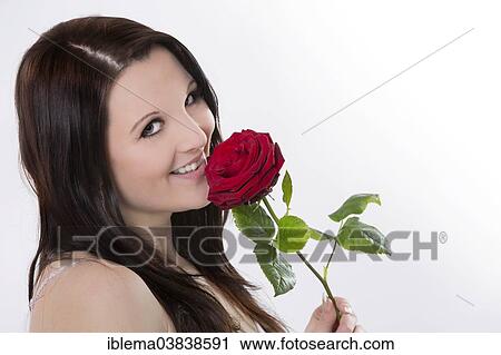 Smiling young woman with a red rose View Large Photo Image Stock Image - Smiling young woman with a red rose. Fotosearch