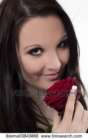 Smiling young woman with a red rose View Large Photo Image Stock Photograph - Smiling young woman with a red rose. Fotosearch