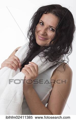 Smiling young woman with a towel around her neck after fitness training View Large Photo Image Stock Photography - Smiling young woman with a towel around her neck after fitness training. Fotosearch