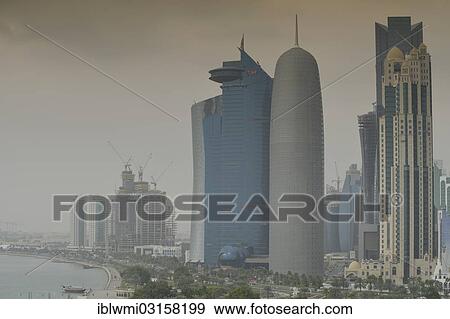 "Smog over Corniche waterfront promenade with the skyline of Doha with Al Bidda Tower, World Trade Center, Palm Tower 1 and 2, Burj Qatar Tower, Doha, Doha, Qatar, Asia" View Large Photo Image Stock Photo - "Smog over Corniche waterfront promenade with the skyline of Doha with Al Bidda Tower, World Trade Center, Palm Tower 1 and 2, Burj Qatar Tower, Doha, Doha, Qatar, Asia". Fotosearch