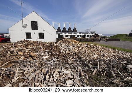 Stock Photo - "Smokehouse with firewood needed for smoking, Bornholm, Svaneke |Svaneke|, Region Hovedstaden, Denmark, Europe". Fotosearch