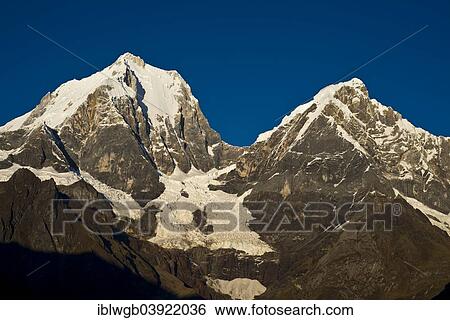 "Snow capped mountains in morning light, Yerupaja Grande, Yerupaja Chico, Cordillera Huayhuash mountain range, Andes, northern Peru, Peru, South America" View Large Photo Image Stock Photograph - "Snow capped mountains in morning light, Yerupaja Grande, Yerupaja Chico, Cordillera Huayhuash mountain range, Andes, northern Peru, Peru, South America". Fotosearch
