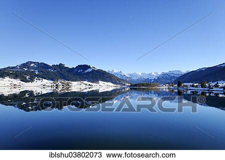 "Snow-capped mountains reflected in the Sihl reservoir, high valley of Einsiedeln, Schwyz, Switzerland, Europe" View Large Photo Image Stock Image - "Snow-capped mountains reflected in the Sihl reservoir, high valley of Einsiedeln, Schwyz, Switzerland, Europe". Fotosearch