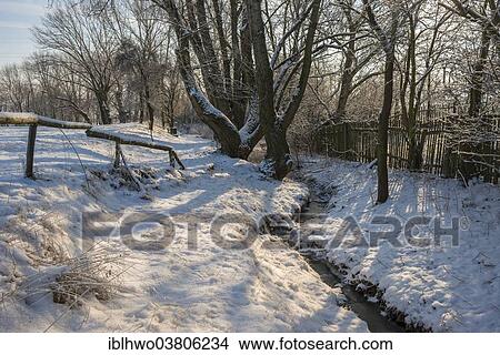 Picture - "Snow-covered hiking trail on a creek, Kromsdorf, Thuringia, Germany, Europe". Fotosearch