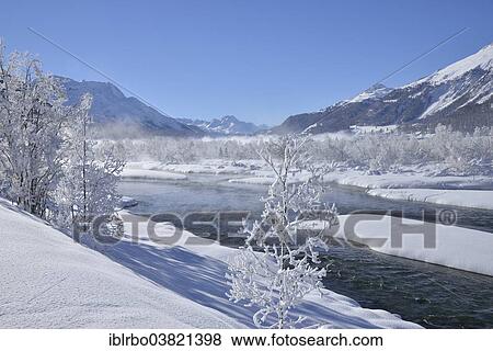 Stock Photo - "Snow-covered landscape and the Inn River, Bever, Engadine, Canton of Graubunden or Grisons, Switzerland, Europe". Fotosearch
