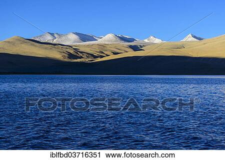 Stock Image - "Snow covered mountains behind Tsomoriri or Lake Moriri, 4. 595 m, Korzok, Ladakh, Jammu and Kashmir, India, Asia". Fotosearch