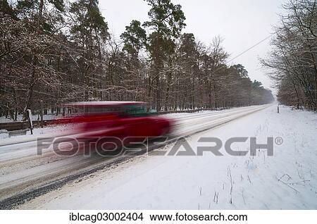 "Snow-covered road in winter with a fast car passing, Morfelden, Hesse, Germany, Europe" View Large Photo Image Picture - "Snow-covered road in winter with a fast car passing, Morfelden, Hesse, Germany, Europe". Fotosearch