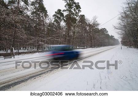"Snow-covered road in winter with car passing by quickly, Morfelden, Hesse, Germany, Europe" View Large Photo Image Stock Photograph - "Snow-covered road in winter with car passing by quickly, Morfelden, Hesse, Germany, Europe". Fotosearch